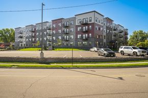 Plymouth apartment for rent - a large apartment building on the corner of a parking lot