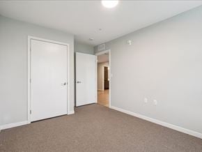 Iowa City apartment for rent - A room with two white doors and a carpeted floor.