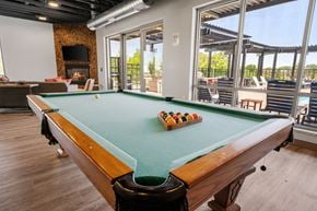Shakopee apartment for rent - a pool table in the resident clubhouse at TRIO @ Southbridge apartments