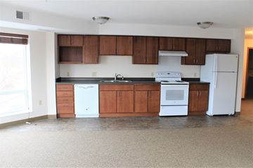 St Paul apartment for rent - A kitchen with white appliances and brown cabinets.