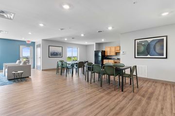 Cedar Rapids apartment for rent - a dining room and living room with a table and chairs