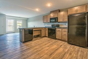 St. Joseph apartment for rent - an empty kitchen with stainless steel appliances and wooden cabinets