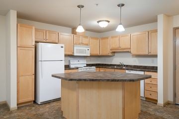 White Bear Lake apartment for rent - a kitchen with white appliances and a granite counter top