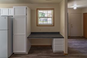 Albany townhouse for rent - A kitchen with a white fridge, a window, and a bench.