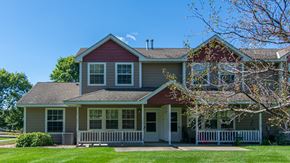 Albany townhouse for rent - A house with a red roof and a white fence.