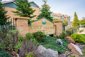 Maple Grove apartment for rent - A sign that says Maple Village in front of a building.