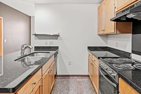 St Paul apartment for rent - A kitchen with a black counter top and a stove.