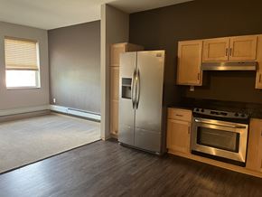 St Paul apartment for rent - A kitchen with a refrigerator, oven, and cabinets.