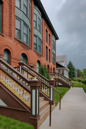 St Paul apartment for rent - A red building with a staircase leading to the front door.