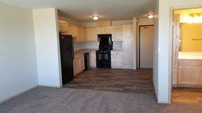Roseau apartment for rent - A kitchen with black appliances and wooden cabinets.