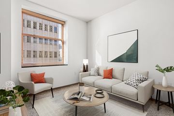 St Paul apartment for rent - A living room with a couch, chair, and a painting on the wall.