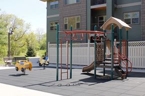 White Bear Lake apartment for rent - A family-friendly playground with a slide and monkey bars.
