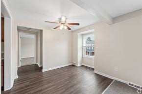Williamsville townhouse for rent - A room with a ceiling fan and wooden flooring.