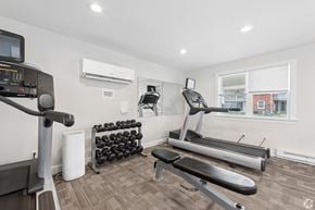 Williamsville townhouse for rent - A home gym with a treadmill, weights, and exercise equipment.