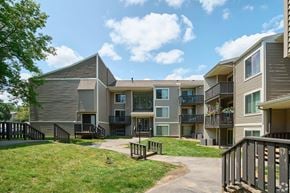 Fairport townhouse for rent - Apartment complex with a walkway between the buildings.