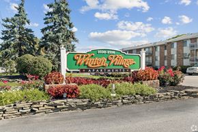 Rochester apartment for rent - A sign for a community named "Wain Village Apartments" is displayed in front of a building.