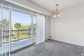 Rochester apartment for rent - A room with a sliding glass door leading to a balcony.