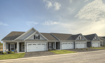 Lancaster townhouse for rent - A large house with a grey roof and white garage doors.