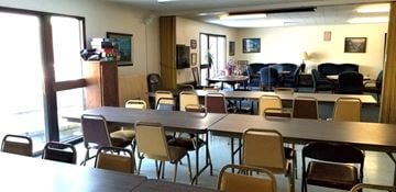 Menasha apartment for rent - a dining room with tables and chairs and a living room with couches