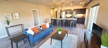 Eau Claire apartment for rent - a living room and kitchen with a couch and a table