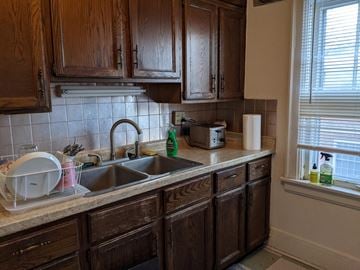 Madison apartment for rent - A kitchen with wooden cabinets and a white sink.