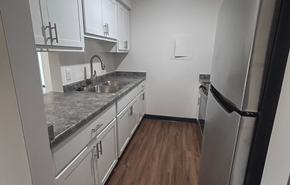 Two Rivers apartment for rent - A kitchen with white cabinets and a granite countertop.