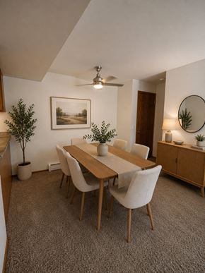 Madison apartment for rent - A dining room with a table, chairs, and a potted plant.