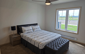 Lancaster apartment for rent - a bedroom with a bed and a large window