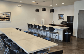 Wisconsin Dells apartment for rent - a conference room with a long table and chairs and a kitchen