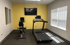 Wisconsin Dells apartment for rent - A gym room with a treadmill, a stationary bike, and a television.