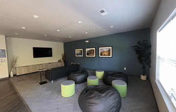 Wisconsin Dells apartment for rent - A living room with a black couch and green ottomans.