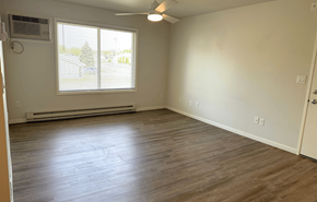 New Glarus apartment for rent - A room with a window and a ceiling fan.