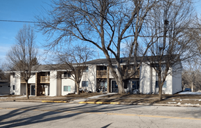 Fall River apartment for rent - a white building with trees in front of it