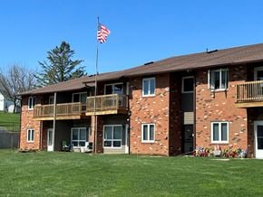 Lancaster apartment for rent - A red brick building with a balcony and an American flag on top.