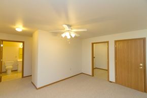 Greenfield apartment for rent - a bedroom with a ceiling fan and a door to a bathroom