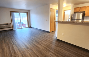 Baraboo apartment for rent - an empty living room with a sliding glass door leading to a balcony