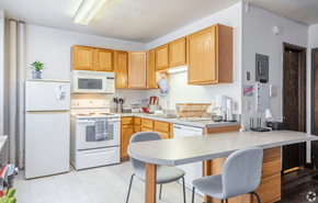 Madison apartment for rent - A kitchen with wooden cabinets and white appliances.