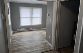 Leroy apartment for rent - A room with a window and wooden floors.