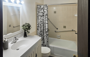 Sun Prairie apartment for rent - A bathroom with a white sink, a white toilet, a white bathtub, and a white shower curtain.