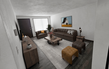 Sun Prairie apartment for rent - A living room with a brown couch, a coffee table, and a painting on the wall.