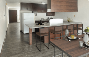 Sun Prairie apartment for rent - A modern kitchen with a dining table set for two.