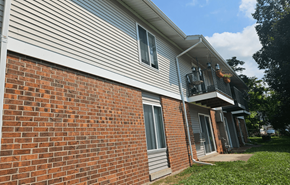 Mount Horeb apartment for rent - A house with a red brick wall and a grey siding.
