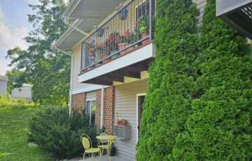 Mount Horeb apartment for rent - A house with a balcony covered in green plants.
