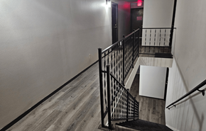 Mount Horeb apartment for rent - A staircase with a black railing and wooden steps.