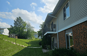 Mount Horeb apartment for rent - A house with a balcony overlooking a green lawn.