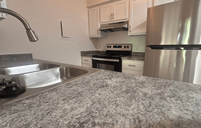 Two Rivers apartment for rent - A kitchen with a stove, oven, and refrigerator.