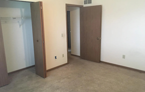 Deforest apartment for rent - A room with a brown door and a white wall.