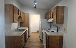 Deforest apartment for rent - A kitchen with wooden cabinets and a white stove top oven.