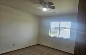 Deforest apartment for rent - A room with a ceiling fan and a window.