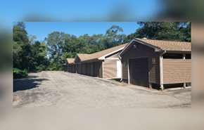 Beloit apartment for rent - A row of garages are lined up on a gravel lot.